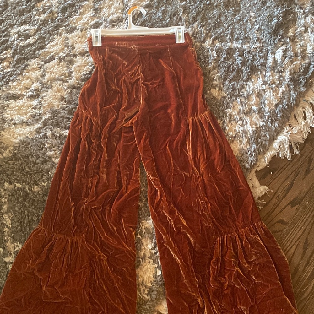Worn once, more of a rust color, velour, and wide legged.